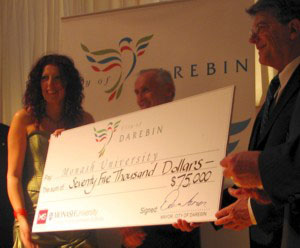 Cr Asmar presents the donation cheque